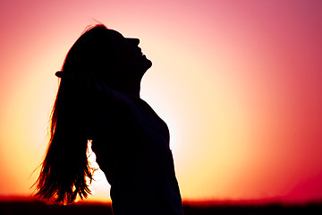 Image showing Woman relaxing at sunset