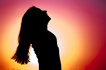 Image showing Woman relaxing at sunset