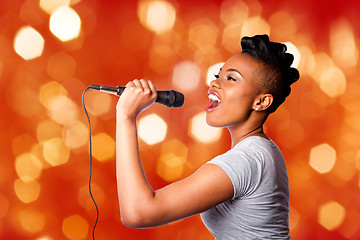 Image showing Singing kareoke woman with microphone