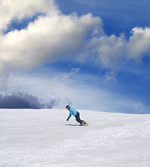 Image showing Snowboarder on ski slope and blue sky