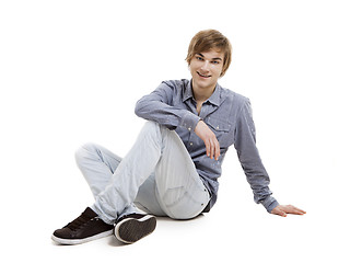 Image showing Young man sitting on the floor