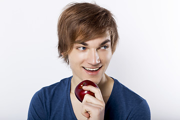 Image showing Young man eating a apple