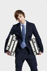 Image showing Business man carrying folders