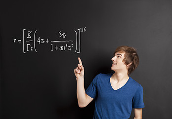 Image showing Young man pointing to a equation