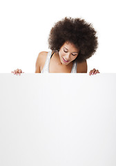 Image showing Woman holding a white billboard