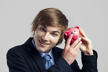 Image showing Shaking a piggy bank