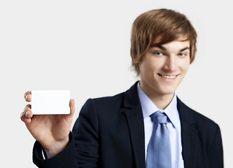 Image showing Businessman holding a business card