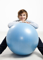Image showing Young man over a pilates ball