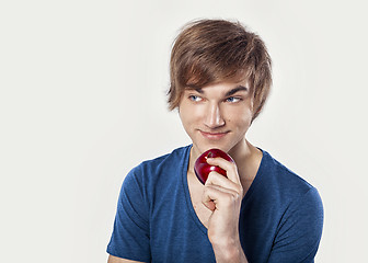 Image showing Young man eating a apple