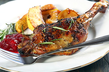 Image showing Duck leg with rosemary and cowberry sauce.