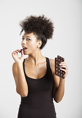 Image showing Woman eating chcolate