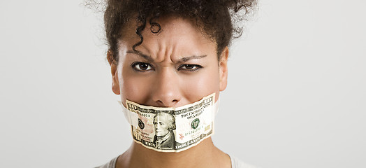 Image showing Covering mouth with a dollar banknote