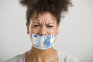 Image showing Covering mouth with a euro banknote