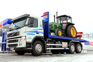 Image showing Volvo FM 370 Truck and John Deere 1640 Tractor as Cargo