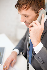 Image showing businessman with laptop computer and phone