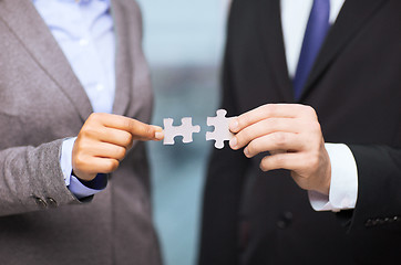 Image showing businessman and businesswoman with puzzle pieces