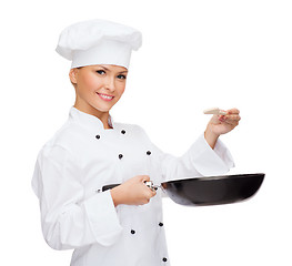 Image showing smiling female chef with pan and spoon