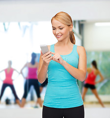 Image showing sporty woman with smartphone