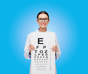 Image showing female doctor in eyeglasses with eue chart