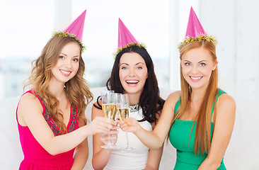 Image showing three women wearing hats with champagne glasses