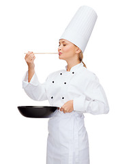 Image showing smiling female chef with pan and spoon