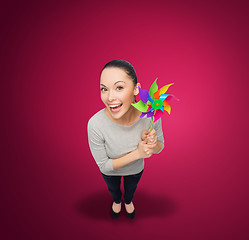 Image showing smiling asian woman with windmill