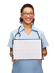 Image showing female doctor in eyeglasses with cardiogram