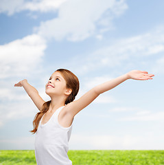 Image showing smiling teenage girl with raised hands