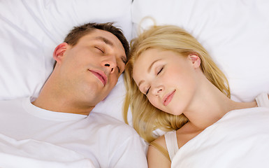 Image showing happy couple sleeping in bed