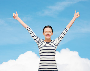 Image showing smiling girl in casual clother showing thumbs up