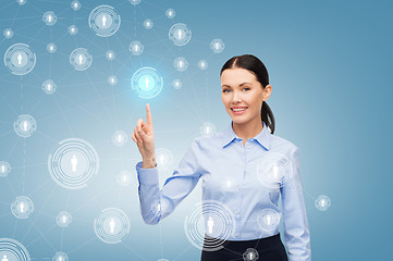 Image showing smiling businesswoman pointing finger at you