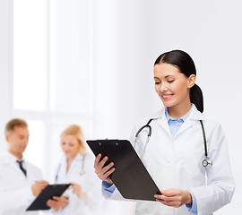 Image showing smiling female doctor with clipboard