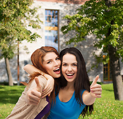 Image showing two smiling girls showing thumbs up