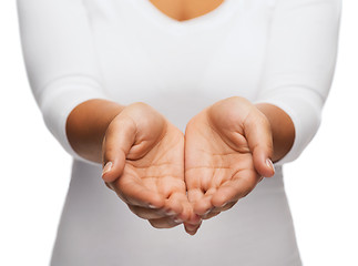 Image showing womans cupped hands showing something