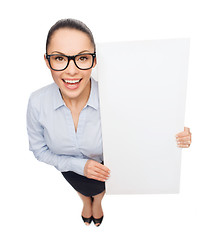 Image showing smiling businesswoman with white blank board