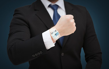 Image showing businessman showing something at his hand