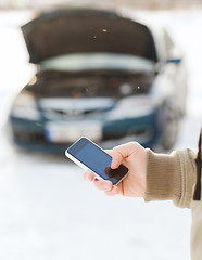 Image showing closeup of man with broken car and cell tphone