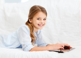 Image showing smiling girl with tablet computer at home