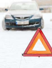 Image showing closeup of warning triangle and car