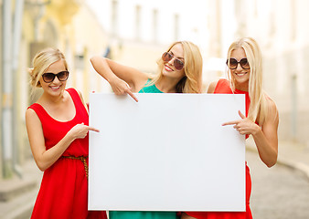 Image showing three happy blonde women with blank white board