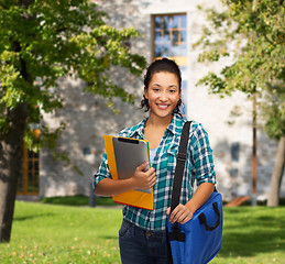 Image showing smiling student with folders, tablet pc and bag