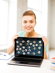 Image showing smiling student girl with laptop at school