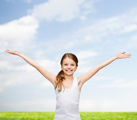 Image showing smiling teenage girl with raised hands