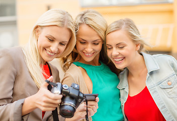 Image showing beautiful blonde women with camera in the city