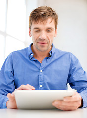 Image showing man working with tablet pc at home