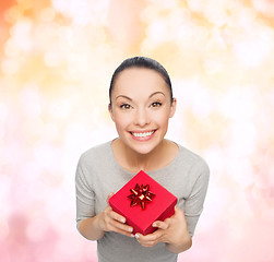 Image showing smiling asian woman with red gift box