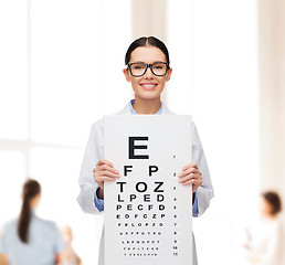 Image showing female doctor in eyeglasses with eye chart