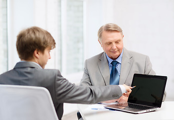 Image showing older man and young man with laptop computer