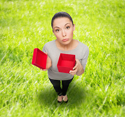 Image showing disappointed asian woman with empty red gift box