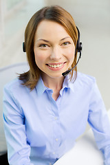Image showing female helpline operator with headphones
